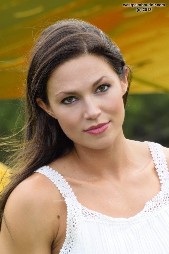 brunette woman, glamour photo, in white dress with airplane