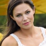 brunette woman, glamour photo, in white dress with airplane